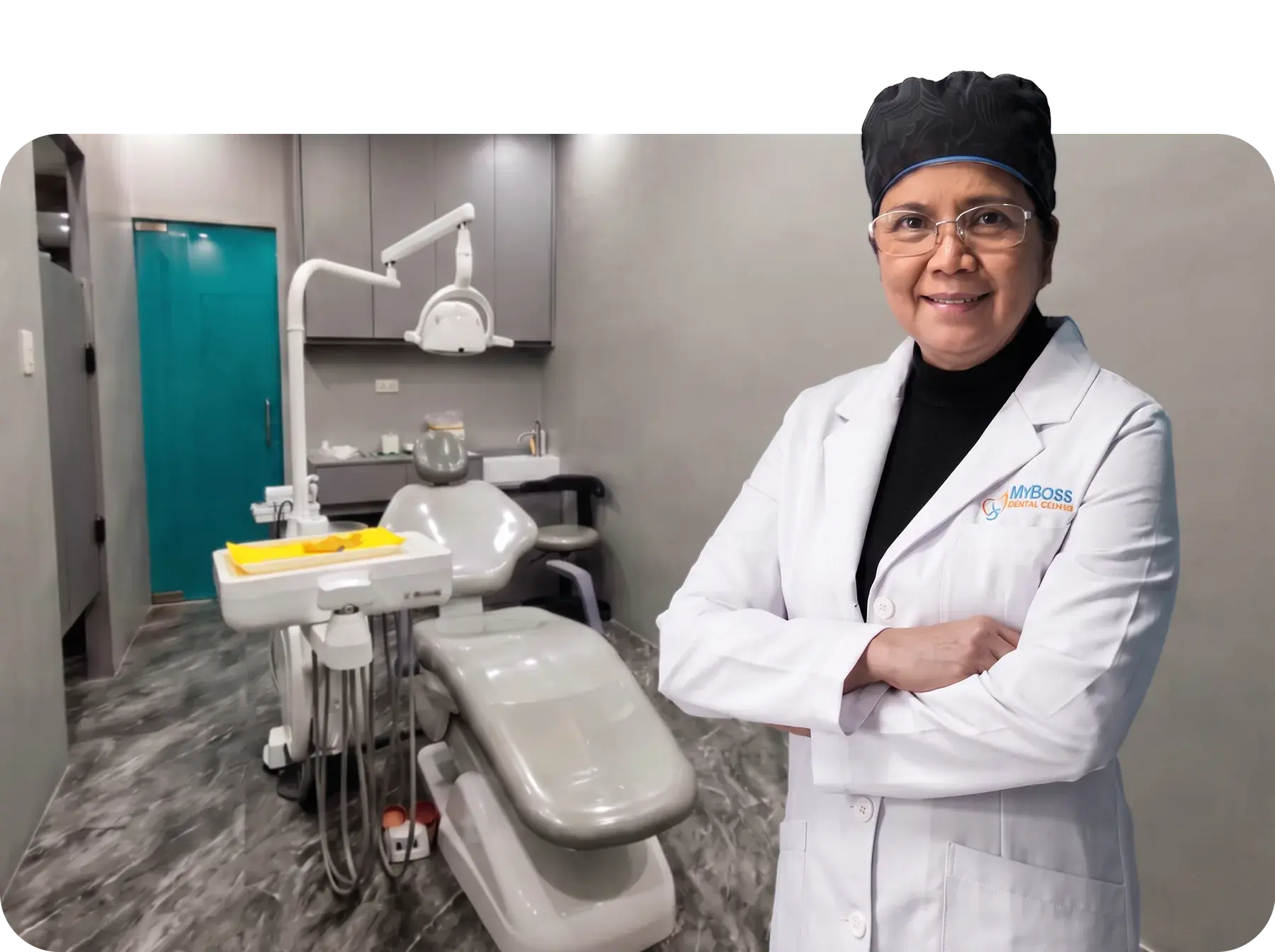 Dr. Minerva De Jesus in a white MyBoss Dental Center coat, standing in the clinic's treatment room